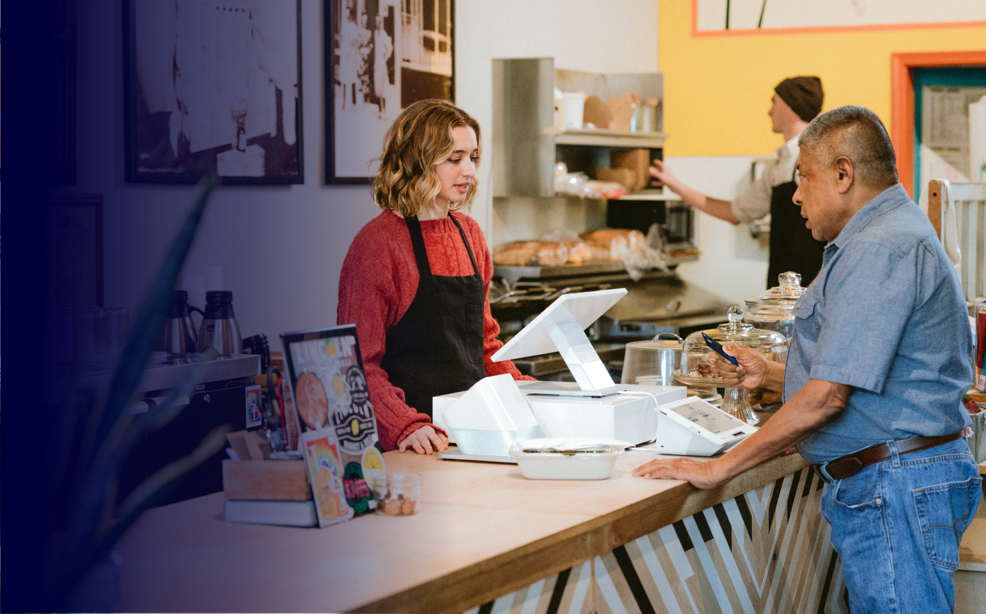 Modern solutions to fit your busines - Person behind counter taking card from customer
